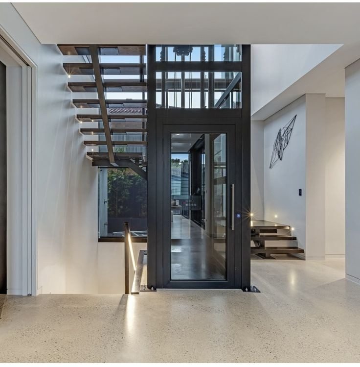 Panoramic glass shaft elevator in a modern home